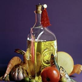 A Bottle Of Olive Oil Surrounded By A Variety by Fotiades