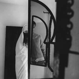 A Male Model Posing In A Mirror With A Woman by Chadwick Hall