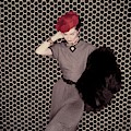 A Model In A Grey Dress And Red Hat