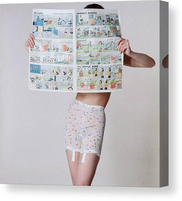 A Model Wearing A Girdle With A Comic Canvas Art Print by Louis Faurer