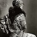 A Model Wearing A Headdress And Brocade Coat