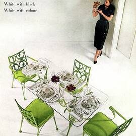 A Patio Table With A Model Standing Behind by Herbert Matter