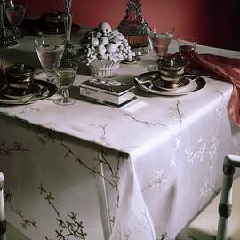 A Table Set With Delicate Tableware by Horst P. Horst