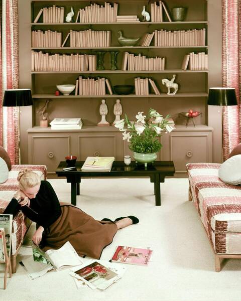 A Woman Reading Magazines On The Floor Art Print