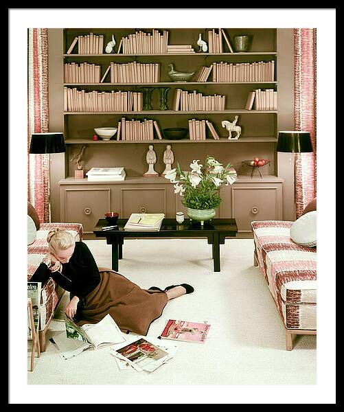A Woman Reading Magazines On The Floor Framed Print