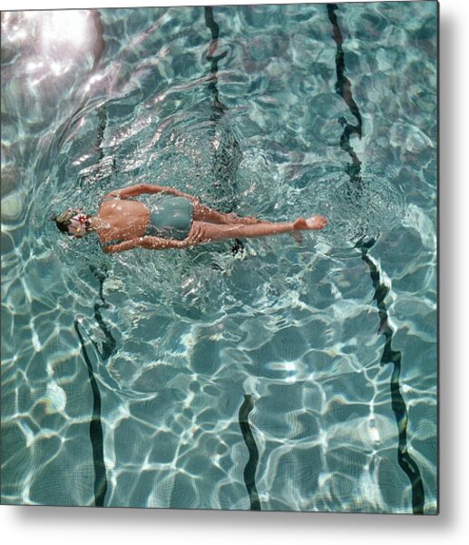 A Woman Swimming In A Pool Metal Print