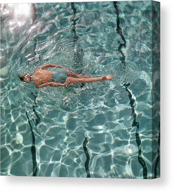 A Woman Swimming In A Pool Canvas Art Print by Fred Lyon