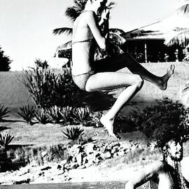 Donna Garrett Jumping Into Swimming Pool by Mike Reinhardt