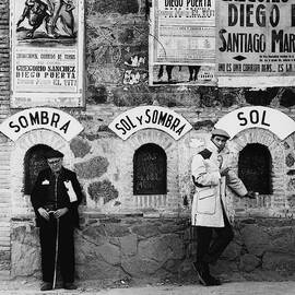 Two Men Posing By A Wall Covered In Spanish by Chadwick Hall