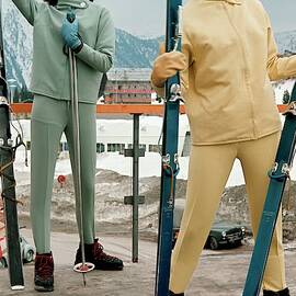 Two Models At A Ski Resort Wearing Outfits by Frances McLaughlin-Gill