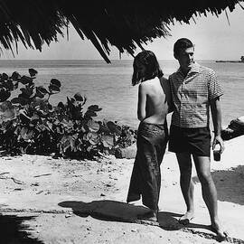 Two Models On A Beach by Peter Levy