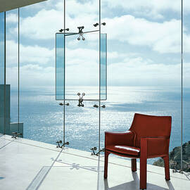 Window In A Glass Wall With Red Chair by Erhard Pfeiffer